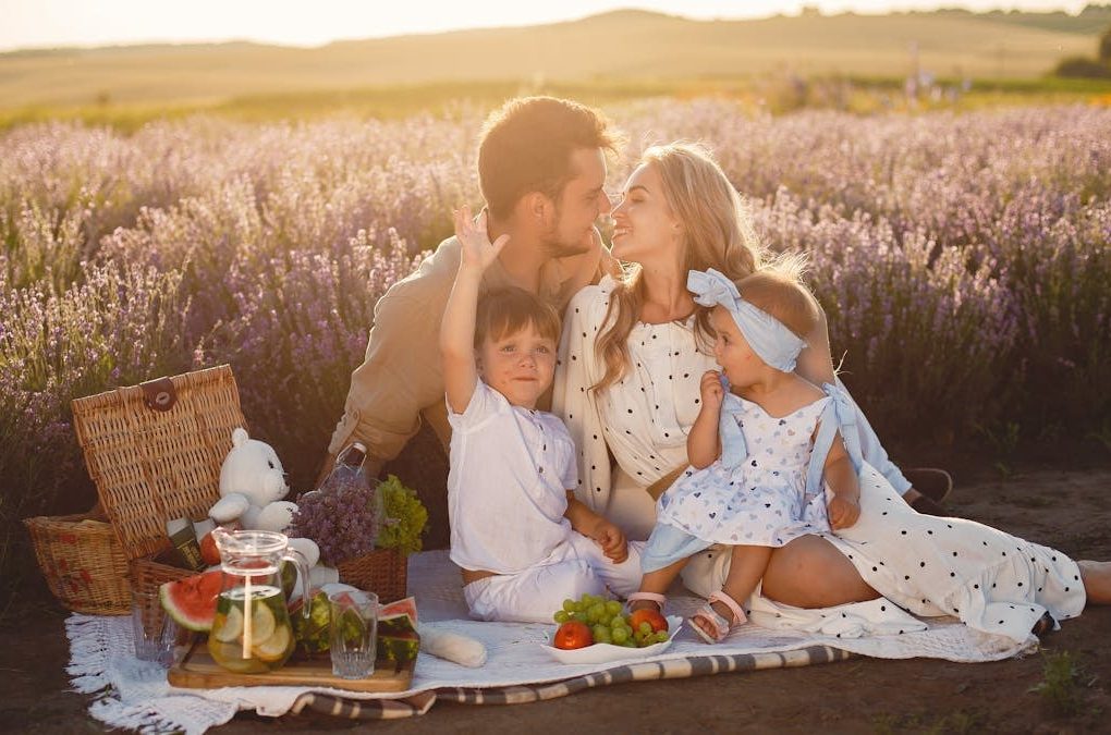 A joyful family picnic in a lavender field, capturing togetherness and love at sunset.