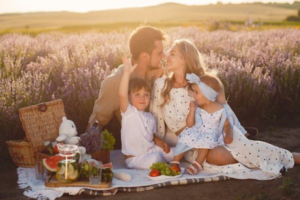 A joyful family picnic in a lavender field, capturing togetherness and love at sunset.
